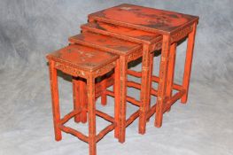 An early 20th Century Oriental quartetto nest of tables, with red ground lacquer decoration, the