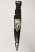 A silver mounted sgian dubh, 8.5cm flattened diamond section blade with faceted back edge,