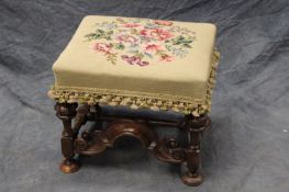 A William and Mary style carved walnut stool, with floral needlepoint seat.