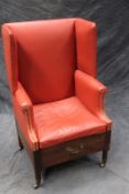 A George III hall porter’s wingback chair, with later close studded leather upholstery.