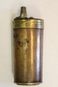 A copper three-way powder flask, the flattened oval body with threaded brass cap to the base,