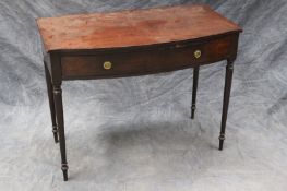 A Regency mahogany bowfront side table, with apron drawer, on slender ring turned tapering legs,