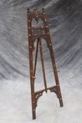 A Moorish style easel, with carved and inlaid decoration, 174cm high.