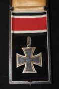 A cased jeweller’s copy of a Knights Cross, complete with ribbon.