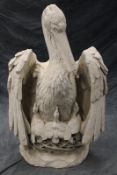 A very large cast plaster figure of a pelican, 120cm high.