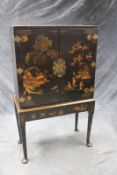 An 18th Century Chinoiserie decorated cabinet on stand, the twin brass mounted door enclosing