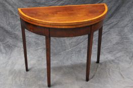 A late Regency mahogany and satinwood banded demi-lune foldover tea table, on square section