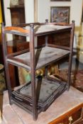 A Chinese hardwood small three tier stand and a nest of three small trays with pierced sides.