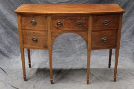 A George III style mahogany and inlaid bowfront sideboard, the central shallow drawer flanked by