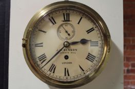 An eight day ship’s clock, with 8 inch dial and subsidiary seconds dial, in a copper case with brass