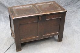 A late 17th Century oak coffer of diminutive proportions, with panel top above conforming front