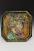 J. Filmont, Caen: a French glazed terracotta wall plaque, in majolica colours, depicting the head