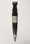 A silver mounted sgian dubh, 10cm flattened diamond section blade, characteristic silver mounted