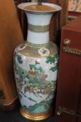 A large Japanese vase, decorated with hunting scenes, now converted for use as a lamp.