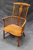 A country made comb back Windsor armchair, with variform central back splat and shaped seat.