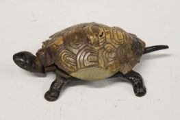 An Edwardian cast iron and faux tortoiseshell table bell in the form of a tortoise, 17cm.