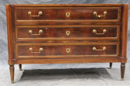 A FRENCH MAHOGANY LOW COMMODE CHEST OF 3 LONG DRAWERS ON SHORT TURNED TAPERED LEGS.