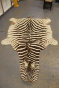 Taxidermy: a zebra skin rug.