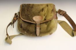 An antique seal skin cartridge bag, leather and canvas strap with brown suede interior.