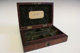 A mahogany case for a pair of muff pistols, the lid with maker’s trade label for Beattie, 223 Regent