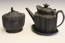 An early 19th Century black basalt teapot possibly Leeds, the hinged lid with urn finial,