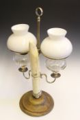 A 19th Century table light, the ivory tusk support with silver plated mounts and adjustable column