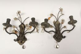 A pair of brass two branch candle light sconces, with glass flowerhead and drop decoration.