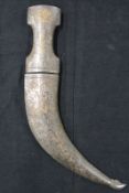 A Jambiya, 21cm sharply curved blade with silver damascene decoration, characteristic iron hilt with