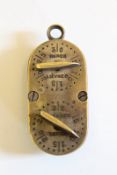 A brass game counter, of rectangular form with rounded ends, four dials for Hare, Rabbit, Pheasant