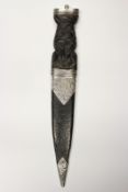 A silver mounted sgian dubh, 10cm flattened diamond section blade with faceted back edge,