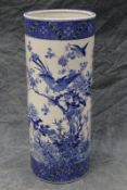 A Japanese blue and white umbrella/stick stand, profusely decorated with birds and flowers, 64cm