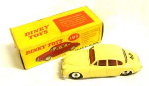 DINKY TOYS NO 195, a good boxed rare Yellow Jaguar 3.4 litre Saloon with applied chequered flag