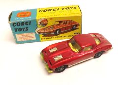 CORGI TOYS NO 310, a good bright boxed Metallic Dark Pink Chevrolet Corvette Sting Ray, (very slight