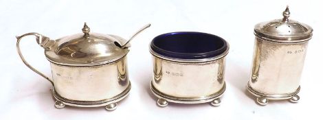 A George V Three Piece Condiment Set, comprising an oval Lidded Pepper, an oval Salt with blue glass