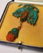 An unusual early 20th Century Pendant in gilt metal with painted leaf and coral inset, possibly
