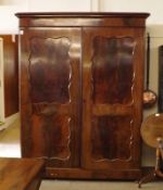 A large 19th Century Mahogany Wardrobe, the moulded cornice to two large panelled doors, the