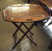 A Victorian Mahogany Butlers Tray of typical form with hinged sides, raised on an oak folding