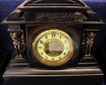 A late 19th Century Black Marble Mantel Timepiece with arched top, central circular face with