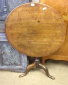 An Oak Circular Pedestal Table, raised on a balustered ring turned support terminating in a tripod