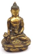 An Oriental gilded Bronze Figure of a seated Deity clutching a Sensor in his left hand and wearing