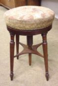 A Victorian Circular Piano Stool with fabric-covered top and screw-thread height adjustment,