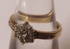 A hallmarked 9ct Gold Diamond Set Cluster Ring of flower head design with stone-set shoulders