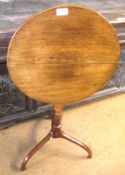 An Oak Circular Pedestal Table, with snap top, ring turned support terminating in a tripod base,