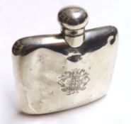 An early 20th Century Hip Flask, of slightly curved form, decorated with engraved crest, overall