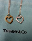 A Tiffany & Co white metal double heart Pendant with trace chain, stamped “.925”, original packaging