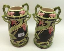 A pair of late 19th/early 20th Century Continental double-handled Vases, decorated with pink