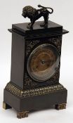 An early 19th Century French Patinated Bronze Mantel Clock, the plinth-shaped case with