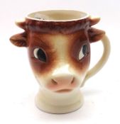 A Novelty Goebel Cow-shaped Mug, decorated in brown on a beige background