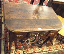 An early 18th Century Oak Lowboy, the top inlaid with a central compass point motif and with rounded