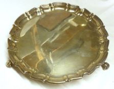 A George V Salver with moulded edge, raised on three scroll feet, 12” diameter, Sheffield 1914,